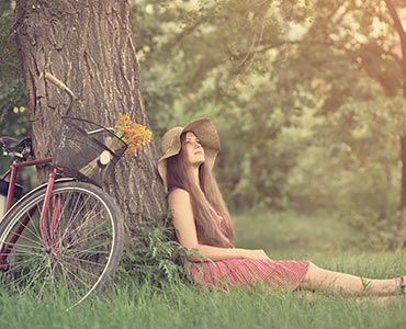 Jeune femme adossée à un arbre