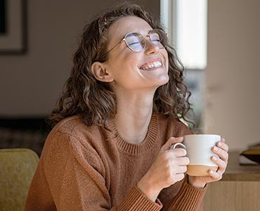 Jeune femme qui boit une tasse café